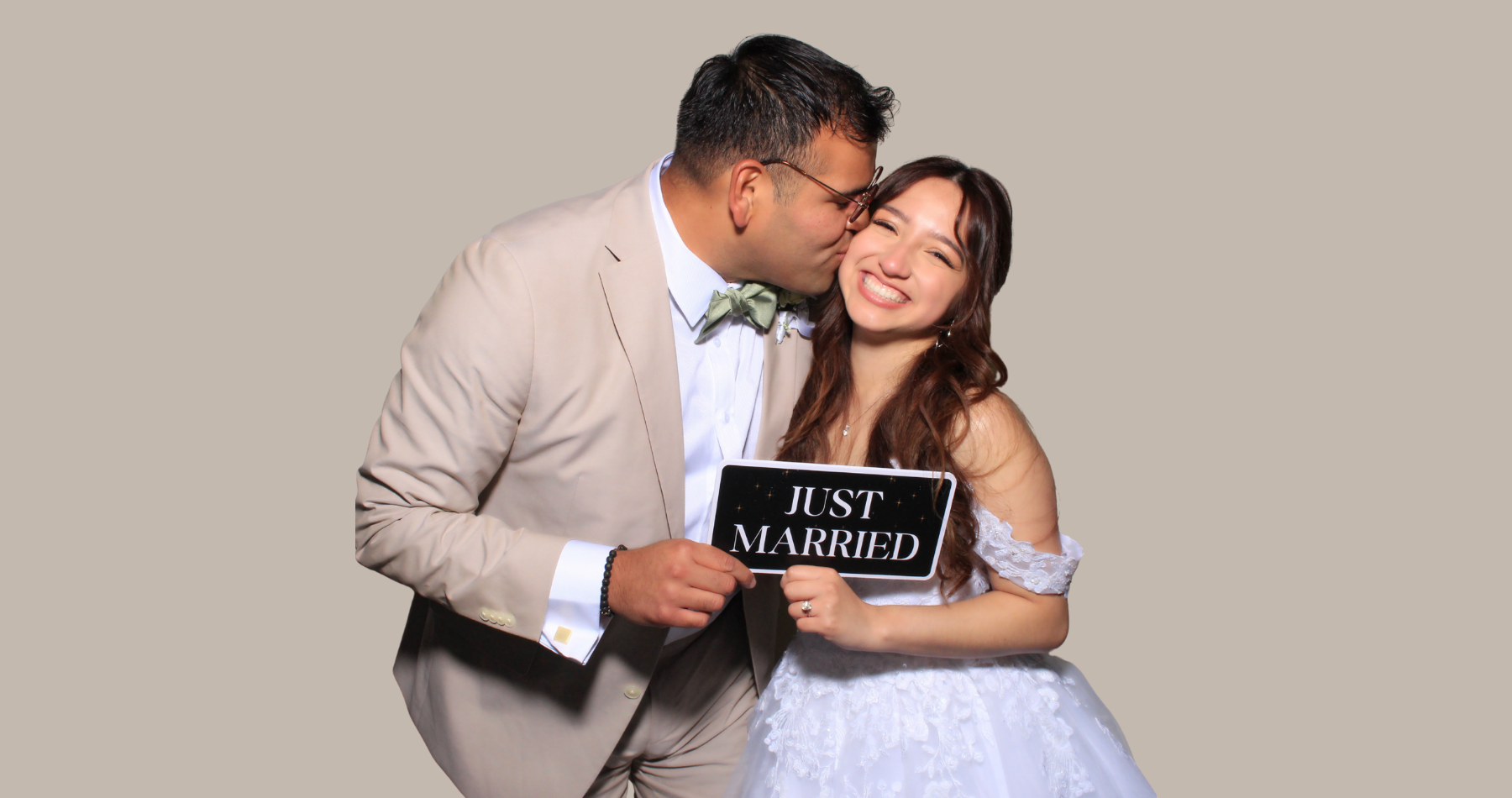 Couple posing in front of Core Memories Photo Booth backdrop during a Bay Area event