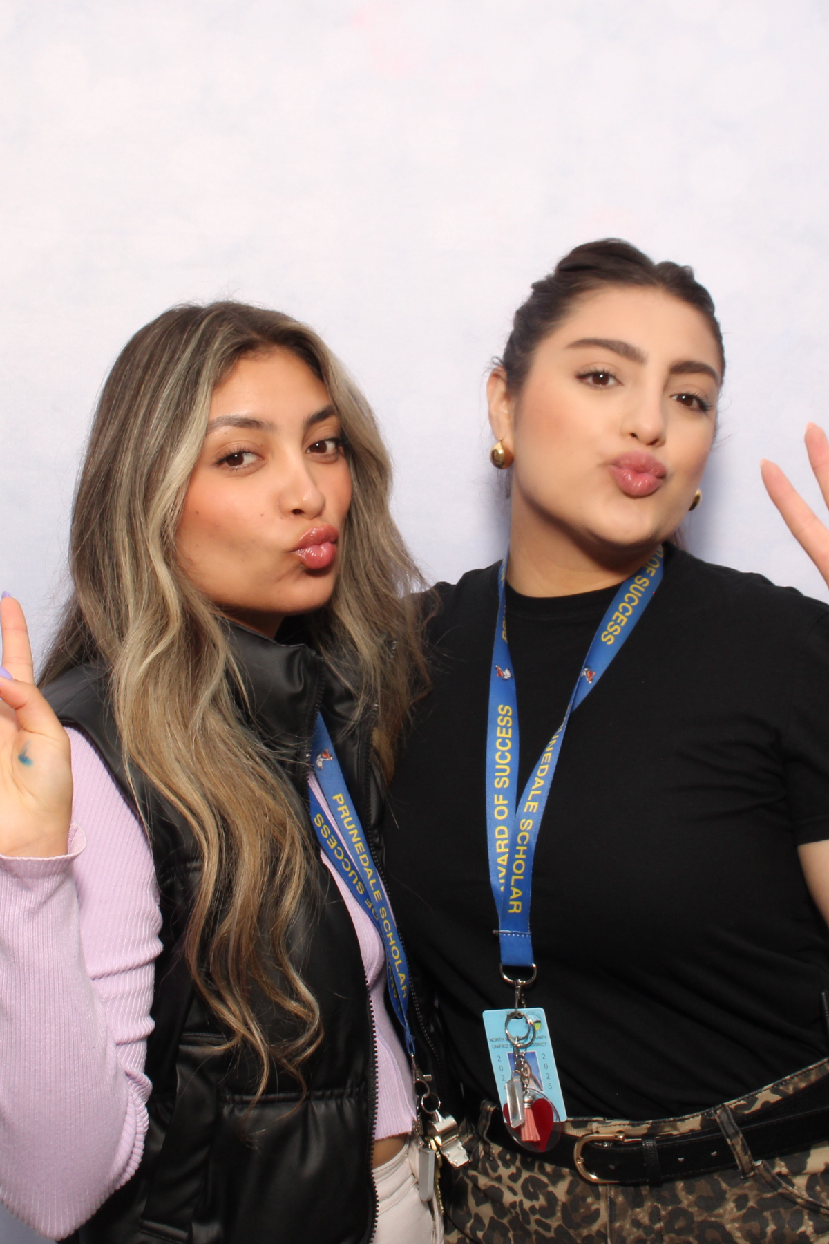 Students posing at a school event photo booth with custom backdrop and instant photo sharing in Monterey County