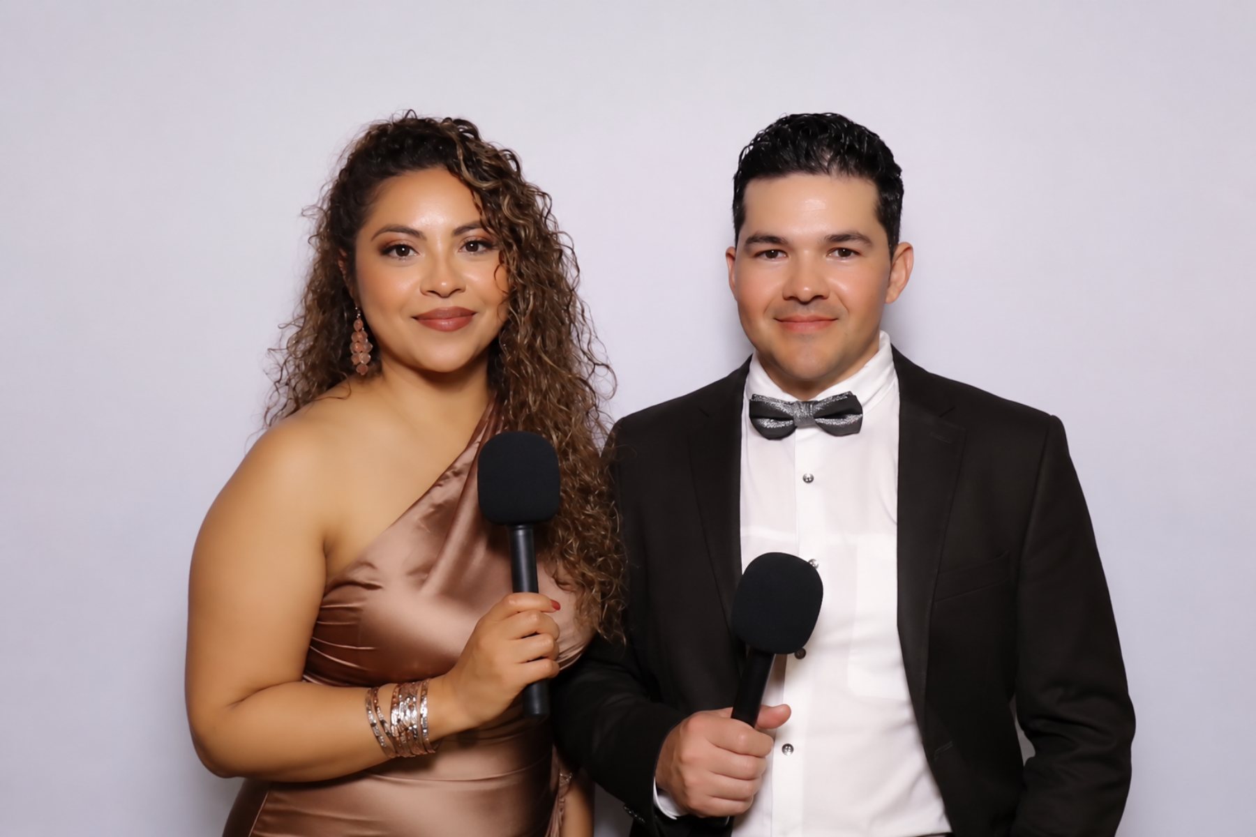 Two guests holding microphones for a video guestbook message