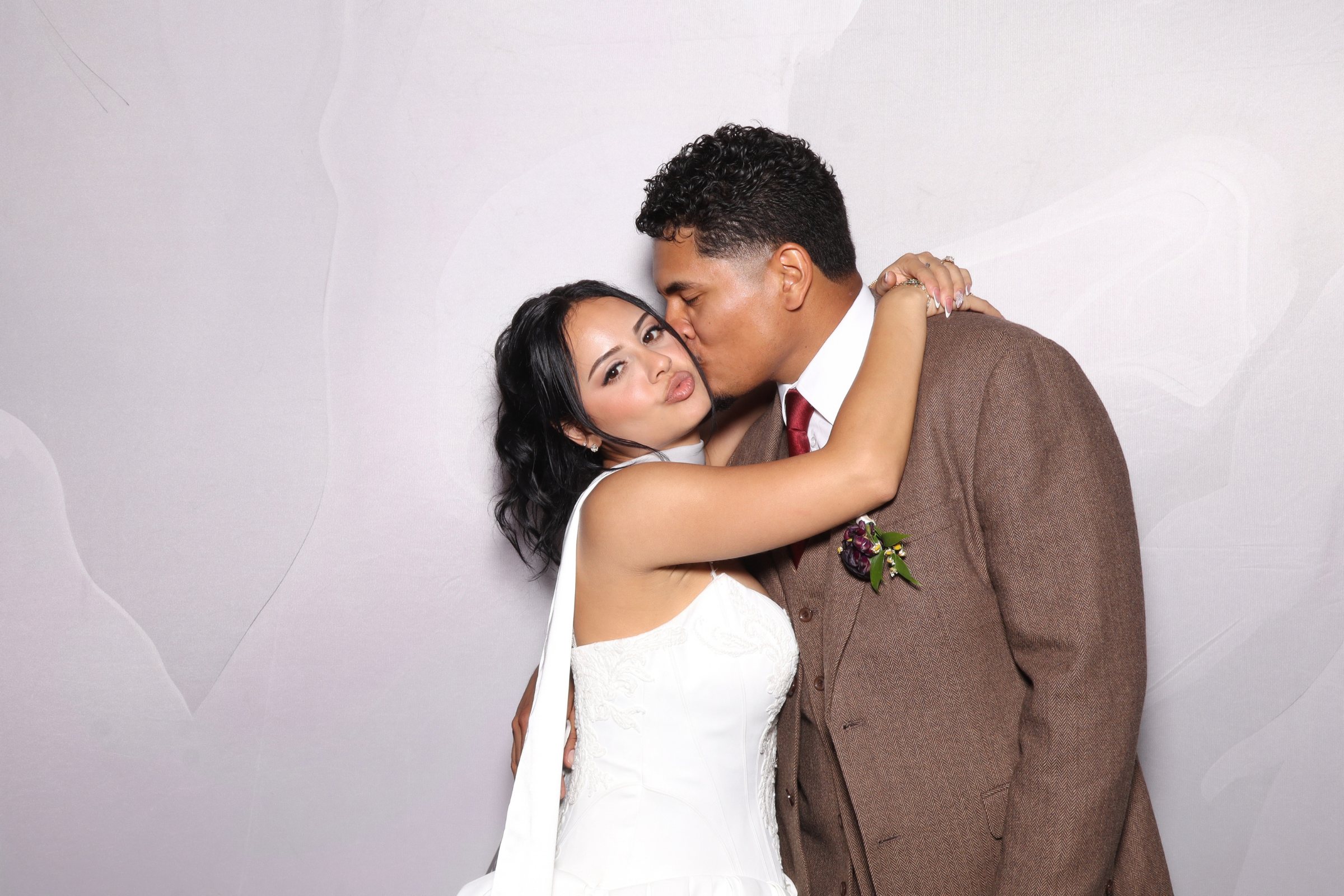 Bride and groom embracing at the photo booth